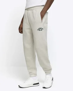 River Island regular fit graphic cuffed joggers< Tracksuits