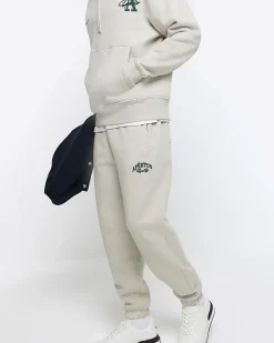 River Island regular fit graphic cuffed joggers< Tracksuits