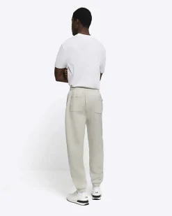 River Island regular fit graphic cuffed joggers< Tracksuits